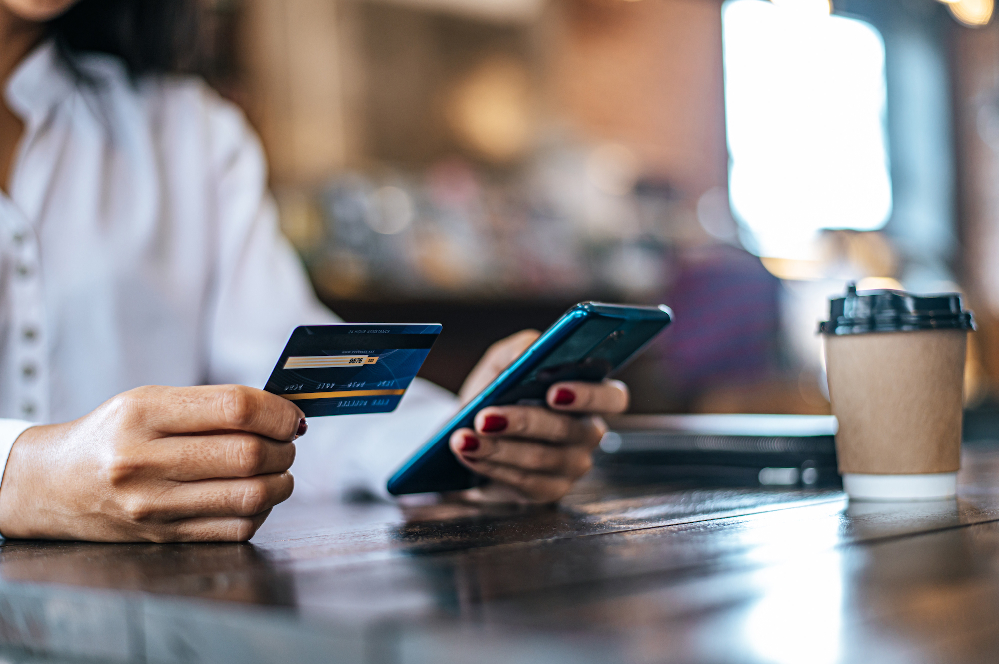 pay-goods-by-credit-card-through-smartphone-coffee-shop.jpg